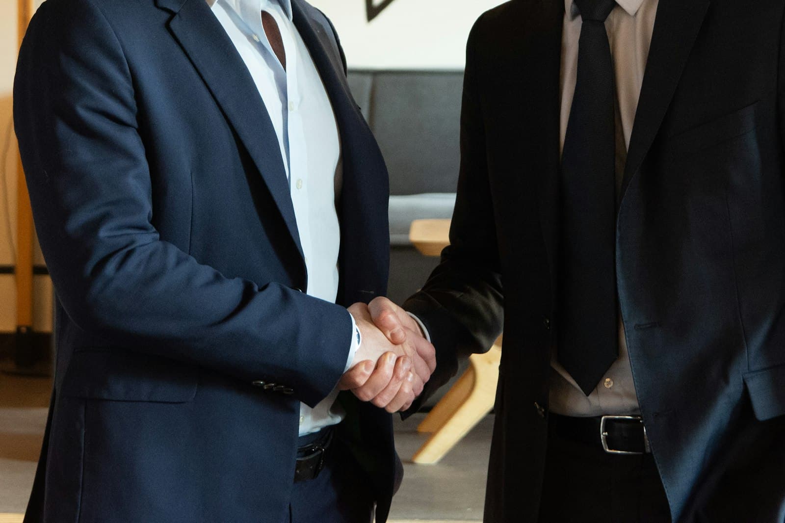 Business partnership handshake — placeholder, to be replaced with a real J.M.V client photo